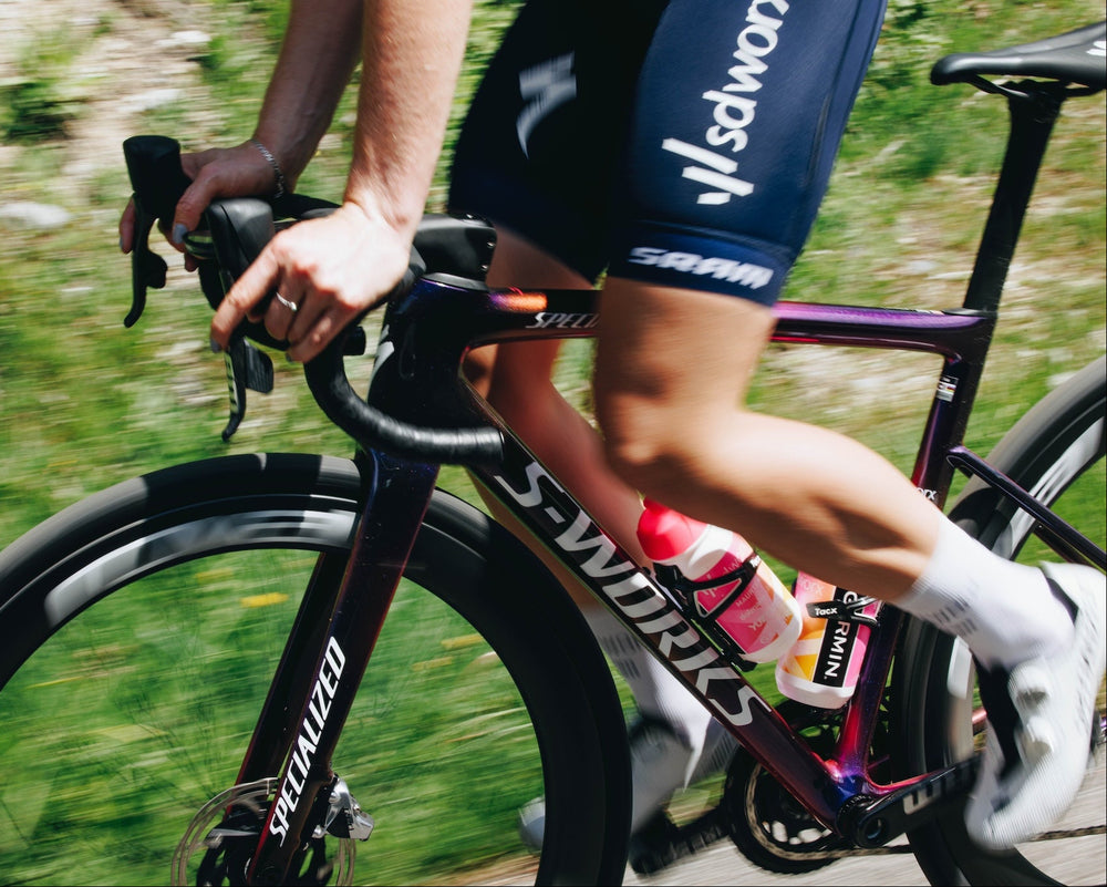 Cyclist riding a Specialized bicycle on a road with a blurred background