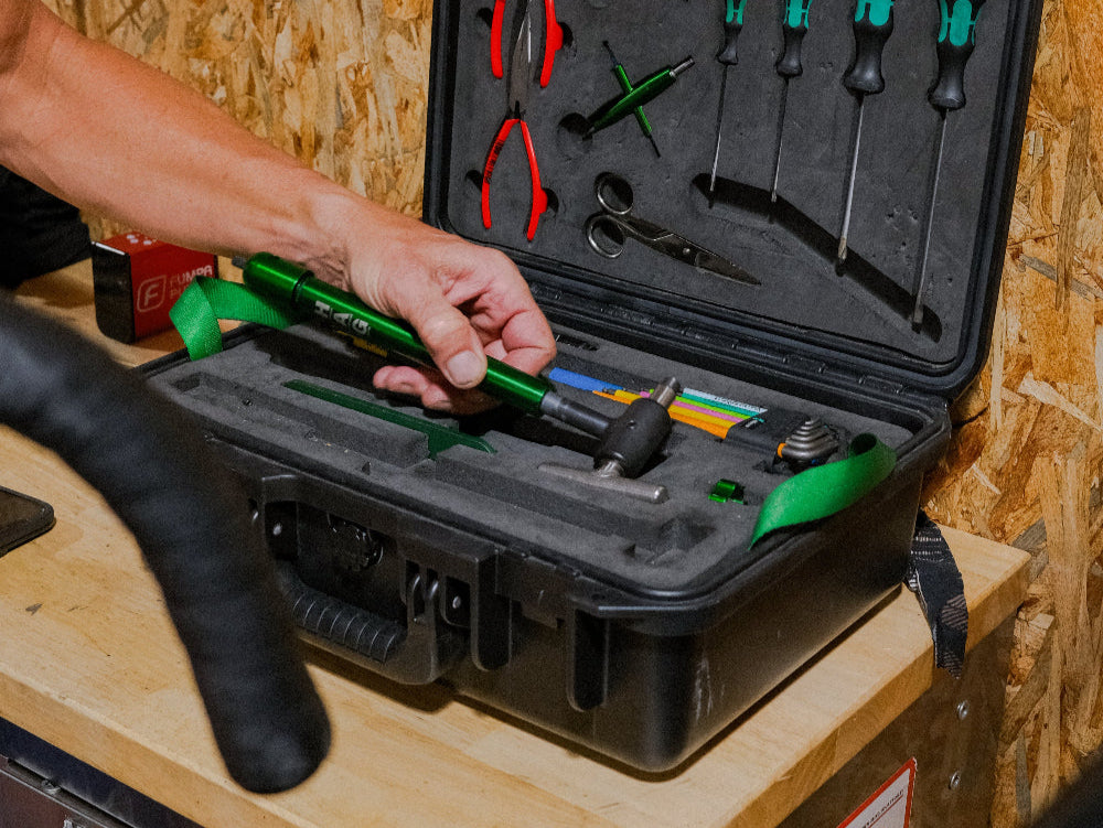 Tool case with various tools on a wooden surface